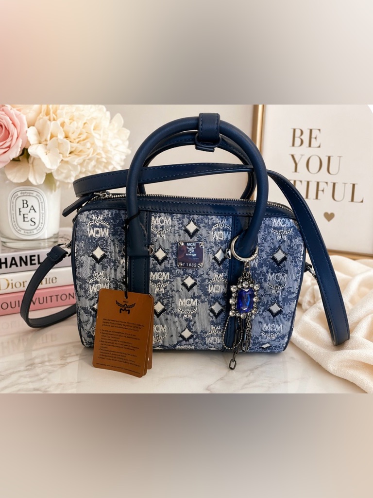 Mcm Denim Barrel Bag Features Leather Trim And Top Handles